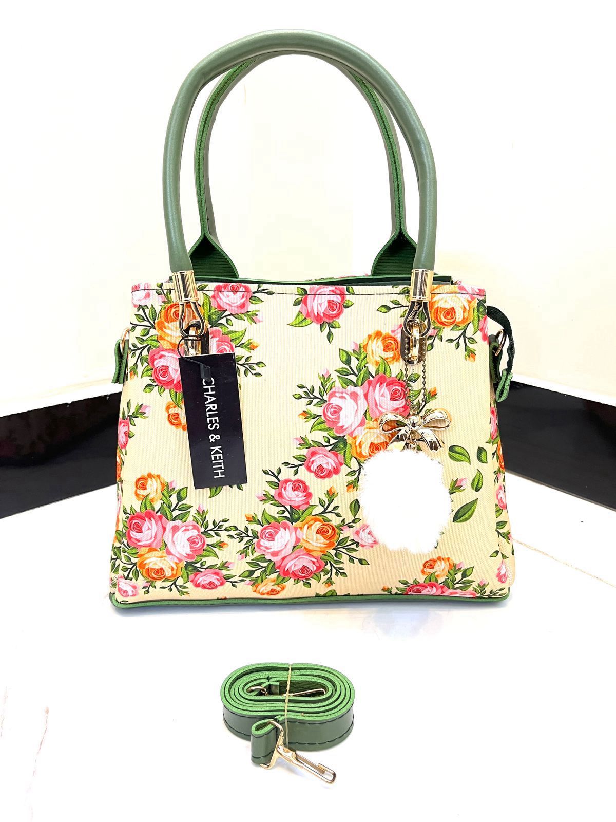 Elegant Floral Pattern Handbag with Stylish Handle and Charm Accent