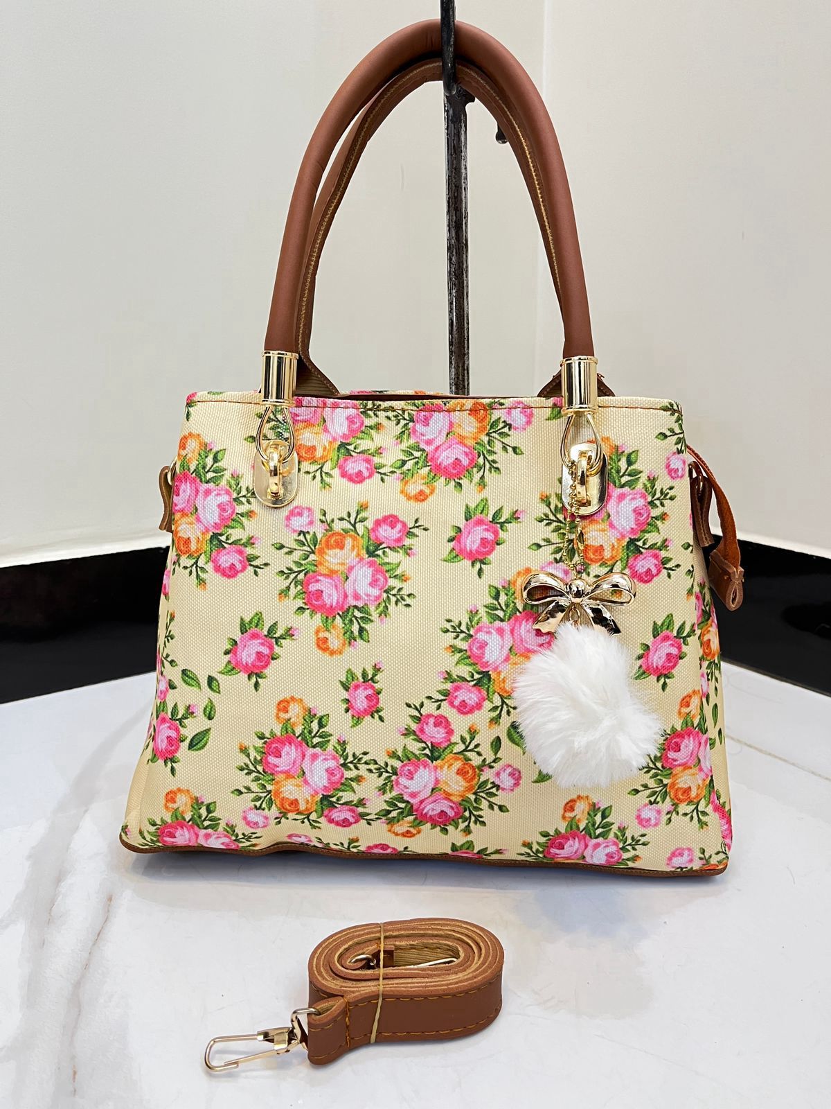 Elegant Floral Pattern Handbag with Stylish Handle and Charm Accent