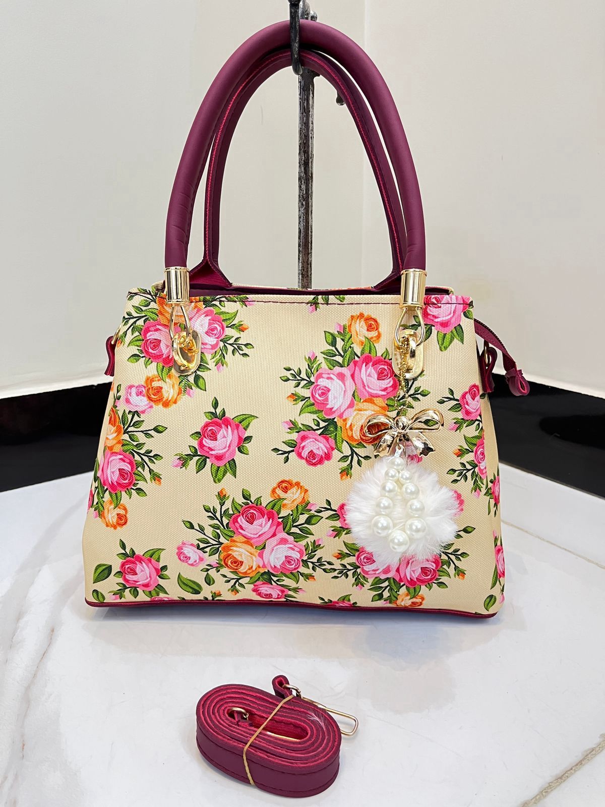 Elegant Floral Pattern Handbag with Stylish Handle and Charm Accent