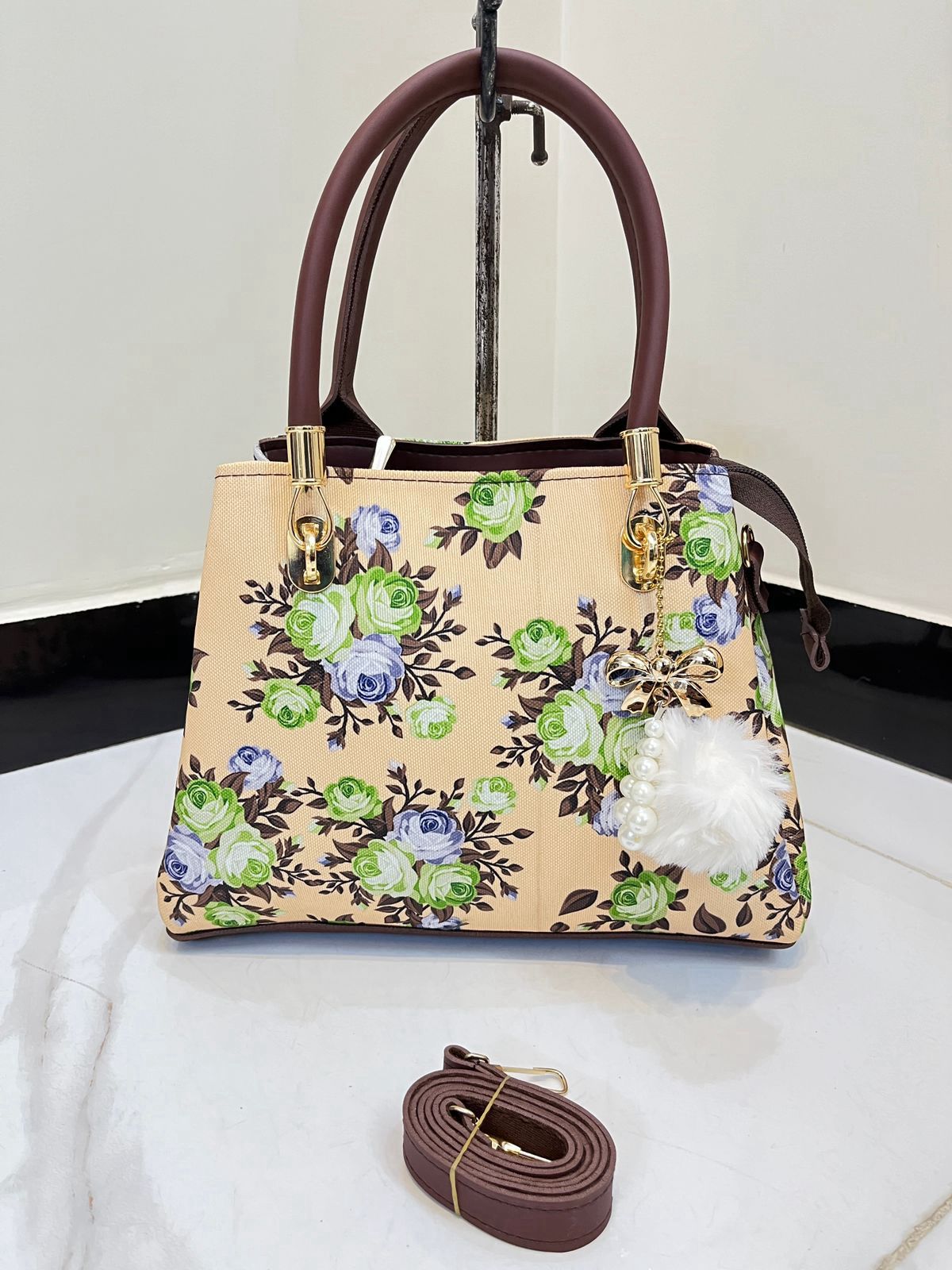 Elegant Floral Pattern Handbag with Stylish Handle and Charm Accent