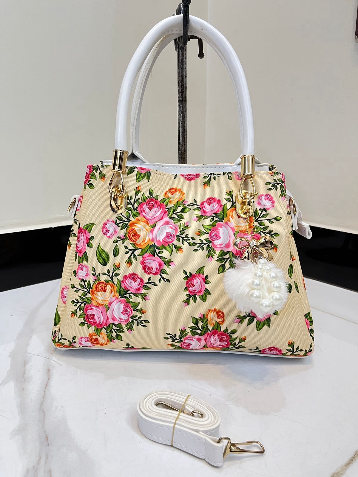 Elegant Floral Pattern Handbag with Stylish Handle and Charm Accent